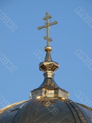 Orthodox Church`s Cupola Cross upon blue sky