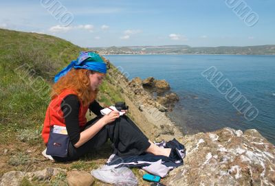 Girl taking notes on the beach