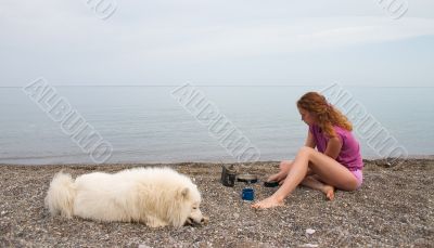 Girl and samoyed on the seaside