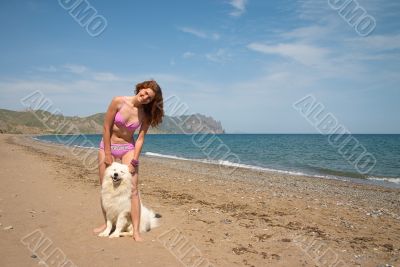 Joyful girl together with samoyed