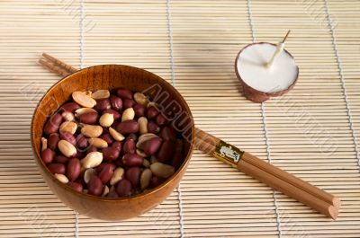 Bowl with peanut and  buddhistic candle