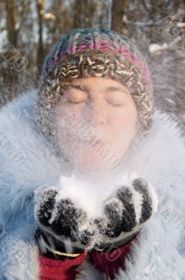 Girl blowing the snow