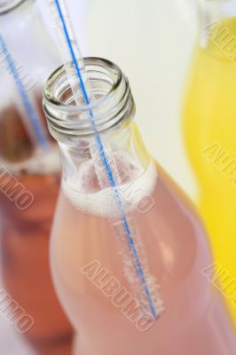 Bottles of soda with straw