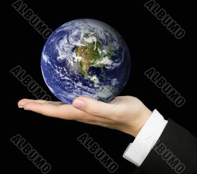 business hand holding earth over black