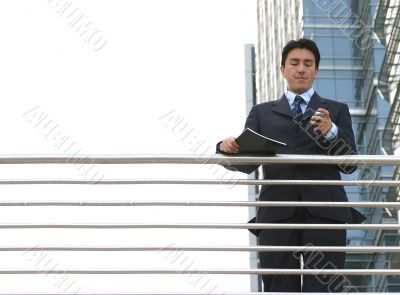 business man dialling on mobile
