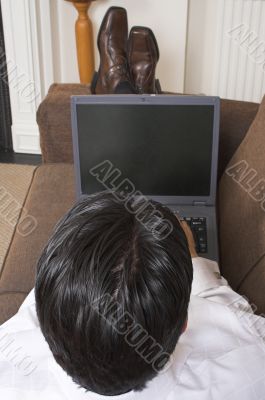 business man relaxing whilst browsing the web business man relaxing whilst browsing the web