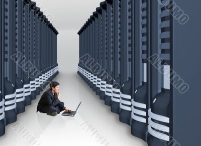 business man with laptop in a server room