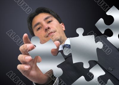 business man arranging puzzle