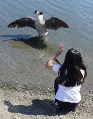 Girl talking to a goose
