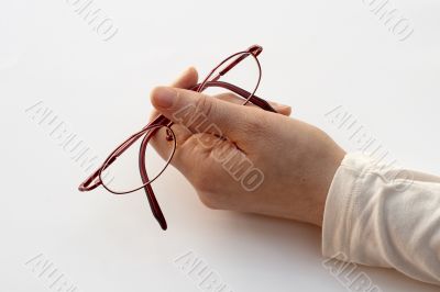 holding pair of glasses