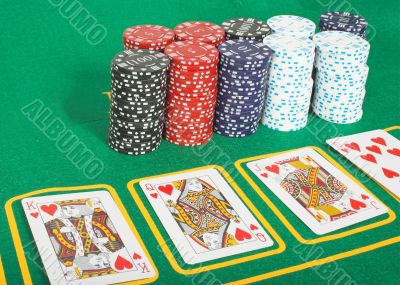 casino tokens and cards showing a royal flush