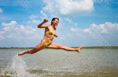 girl jumping above the lake