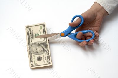 Cutting a ten dollars with scissors