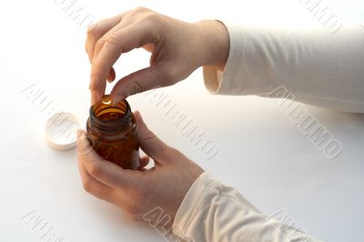 taking a medicine of the bottle