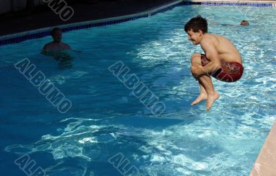 Boy jumping in the pool