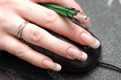 females finger with beauty nails over mouse