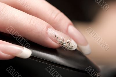 Beauty nails, fingers over computer mouse