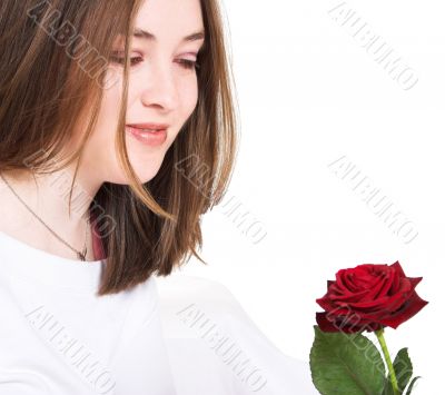 beautiful girl looking at rose - focus on eyes