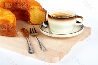 sponge cake with the cup of coffee and spoon