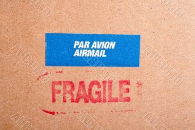 Fragile on cardboard box,  and sticker