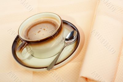 Close-up of a cup of coffee with the spoon