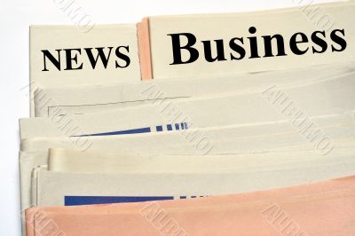 Stacked business newspapers