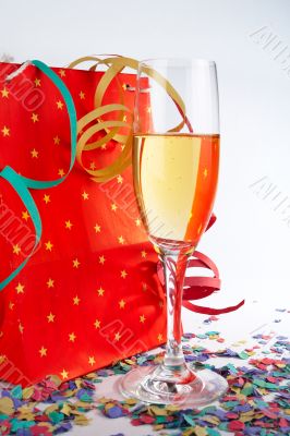 Champagne glass with red shopping bag