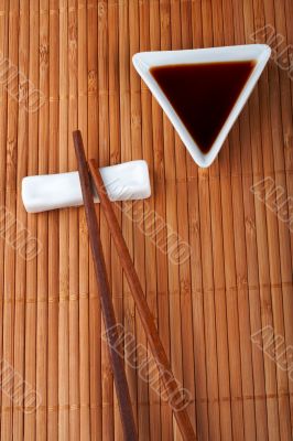 A pair of asian chopsticks and soy sauce