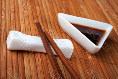 A pair of asian chopsticks and soy sauce