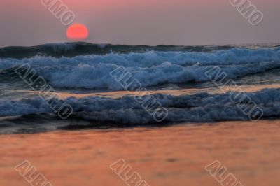 red sunset on waves, atlantic coast