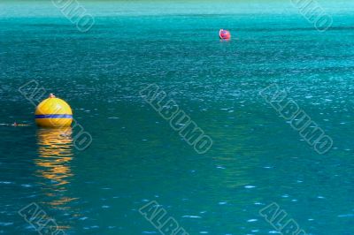 yellow buoy on turquoise sea yellow buoy on turquoise sea
