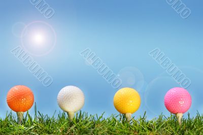 Colored golf balls in the grass