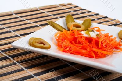 Salad of carrot on a porcelain plate