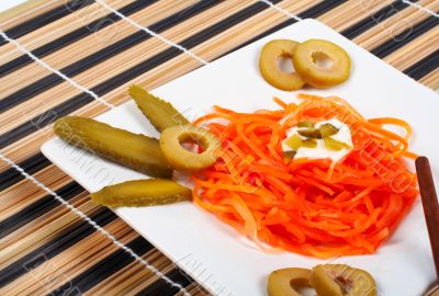 Salad of carrot on a porcelain plate