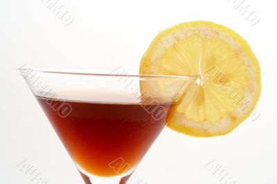 Detail of red cocktail with lemon
