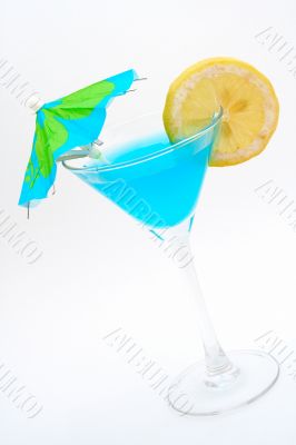 Blue cocktail with lemon and umbrella