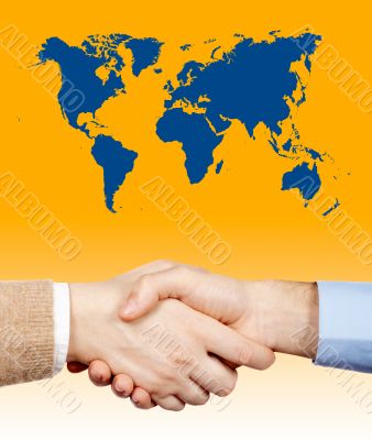 Business handshake under the world