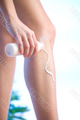 applying body lotion