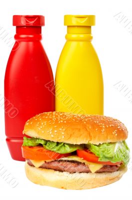 Burger with mustard and ketchup bottles