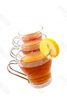 Three glass cups of tea with one slice of lemon