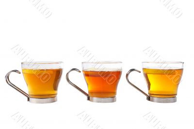 Three glass cups of tea with one slice of lemon