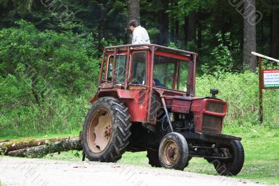 Tractor dragging lumber