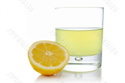 Half and glass of fresh lemon juice Half and glass of fresh lemon juice