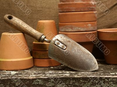 garden trowel leaning on flower pots