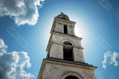 sun behind the bell tower