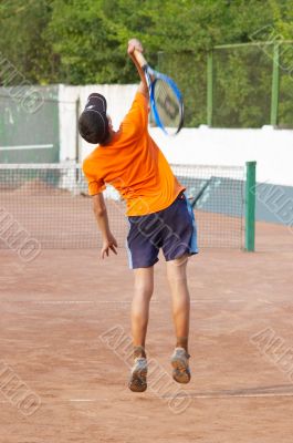 tennis. boy is serving