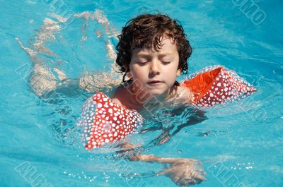 boy learning to swim