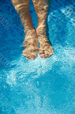 feet refreshing in swimming pool