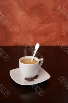 steaming cappuccino with coffee beans