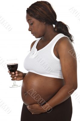 Attractive pregnant woman drinking wine